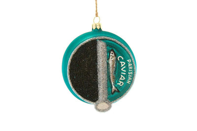 A special green caviar tin Christmas tree ornament. the tin appears to be half opened revealing the caviar pears inside and bearing the words "PARISIAN CAVIAR".